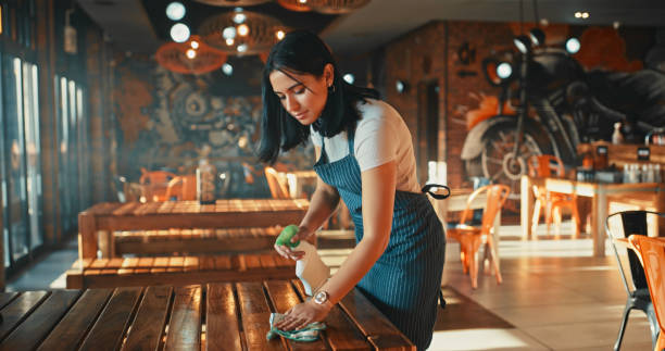 a woman cleaning a table